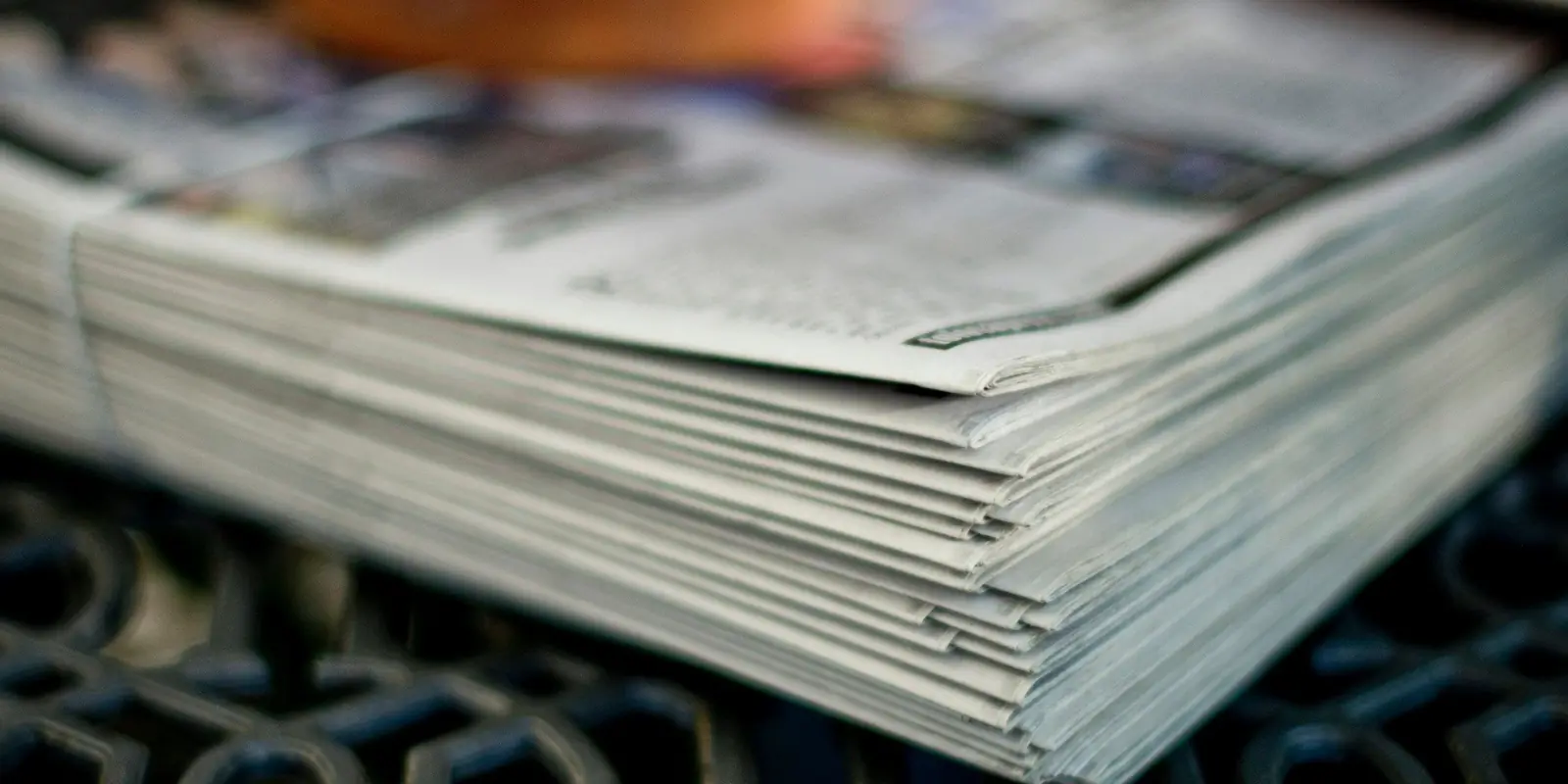 A stack of folded newspapers