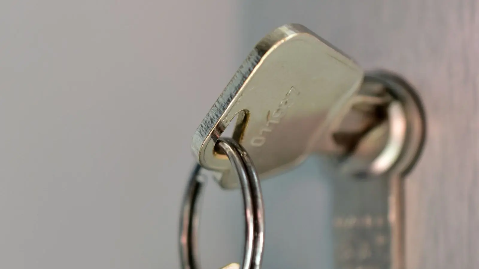 A house key on a key ring in a lock